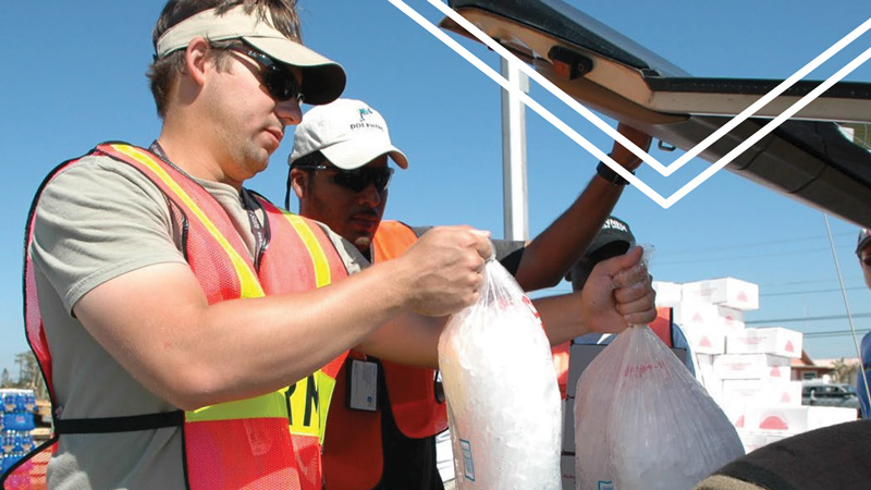 volunteers distributing bags of ice