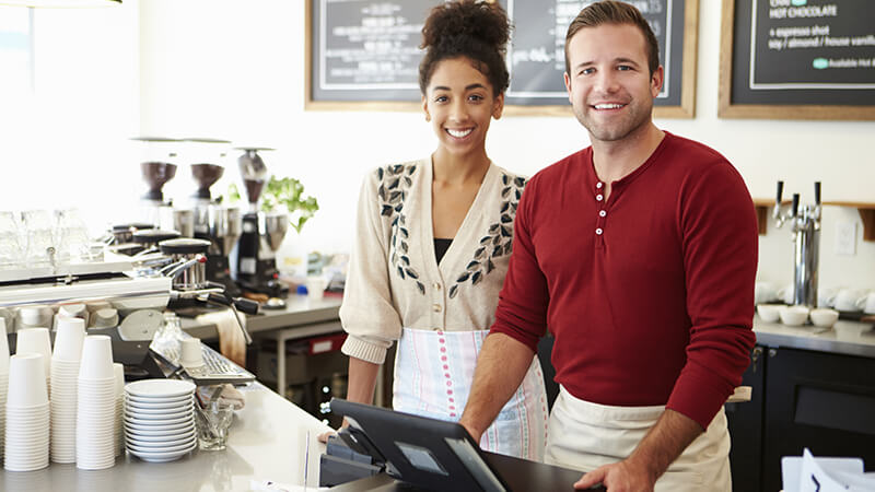 Two people working in a coffee shop.