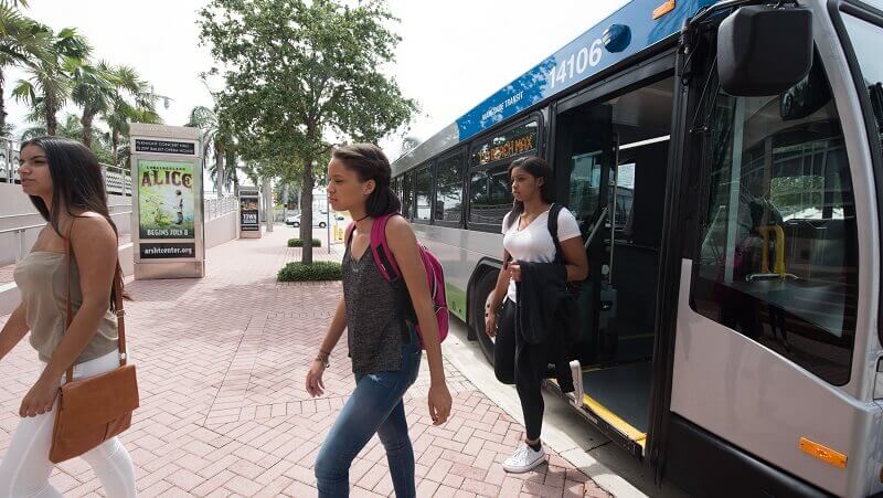Students walking out of a Metrobus.