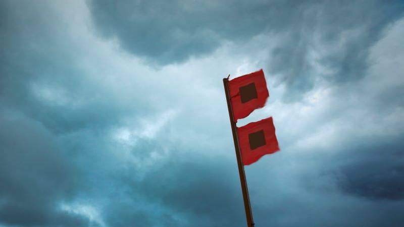 Hurricane warning flags waving during a storm