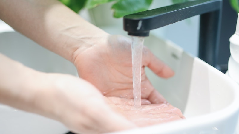 hands being washed under sink with running water