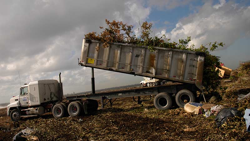 Landfill truck dumps debris